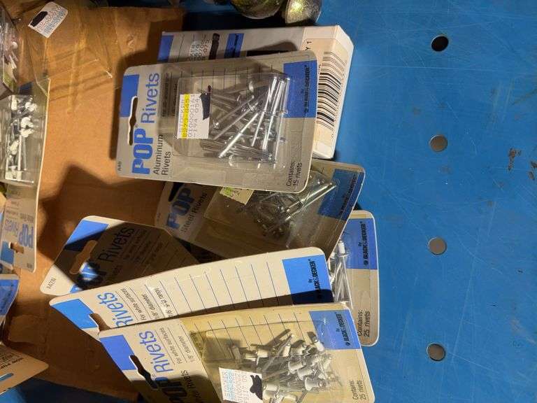 Box of pop rivets mostly unopened, Arrow staples, New Holland parts and more