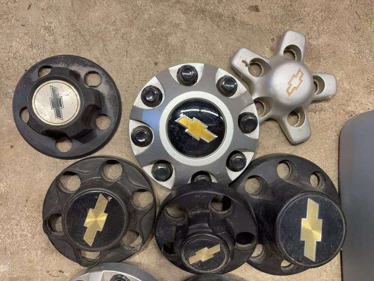 Tote of Chevy hub caps and parts