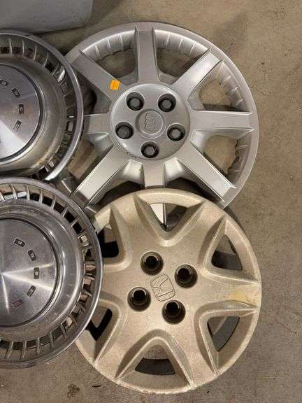Tote of miscellaneous hubcaps - Buick, Honda, and more