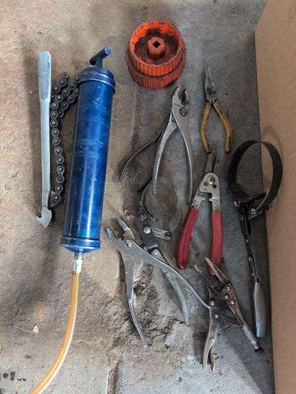 Box of tools - wrenches, pliers, grease gun, and more
