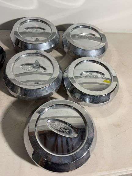Box of Ford and Ruff racing hub caps