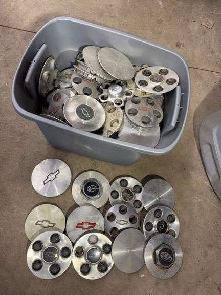 Tote of Chevy hub caps and parts