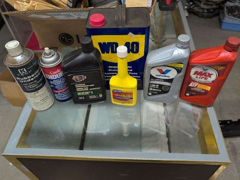 Flat of WD-40, oil, and other mechanic fluids