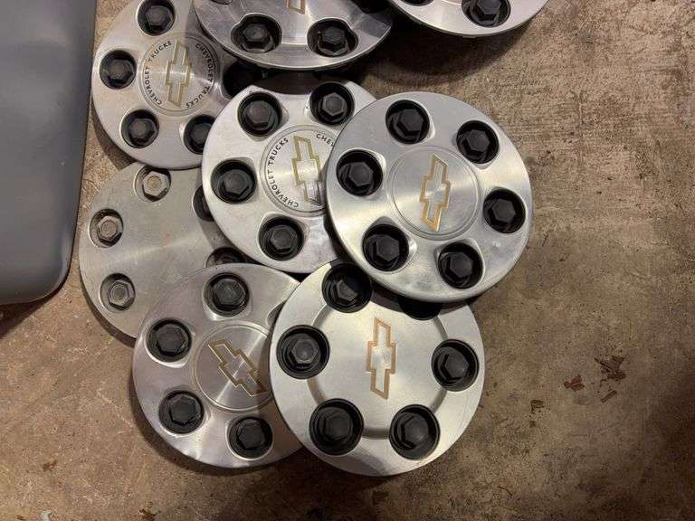 Tote of Chevy hub caps and parts