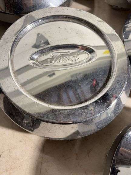 Box of Ford and Ruff racing hub caps