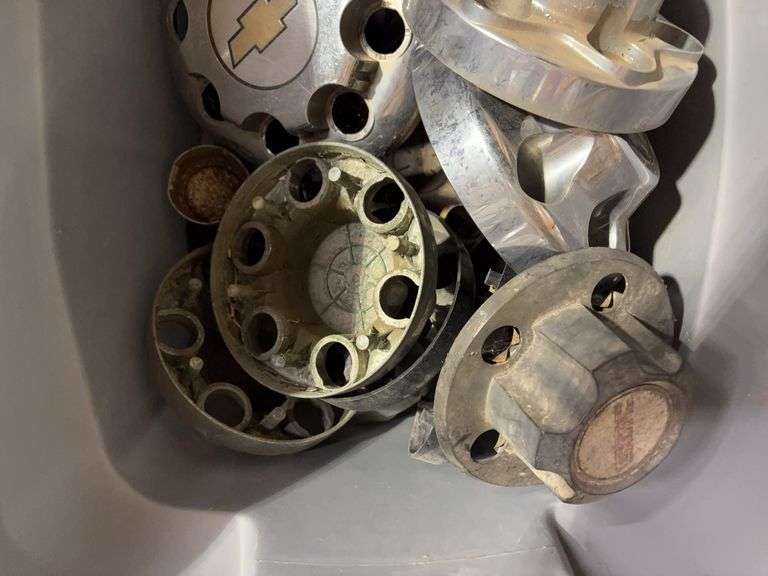 Tote of GMC hub caps and parts