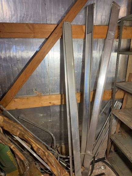 Corner of car parts and scrap metal pieces - as is