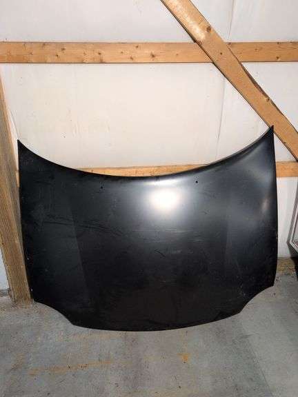Unmarked black vehicle hood - see photos