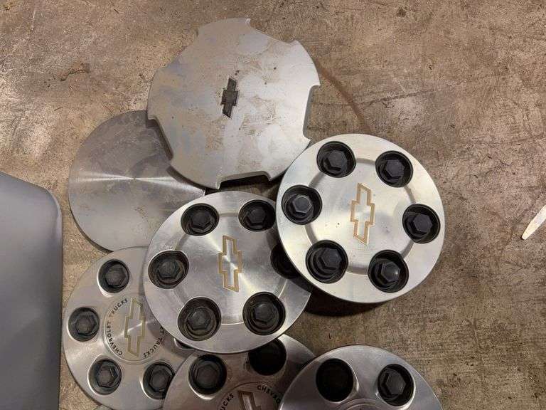 Tote of Chevy hub caps and parts