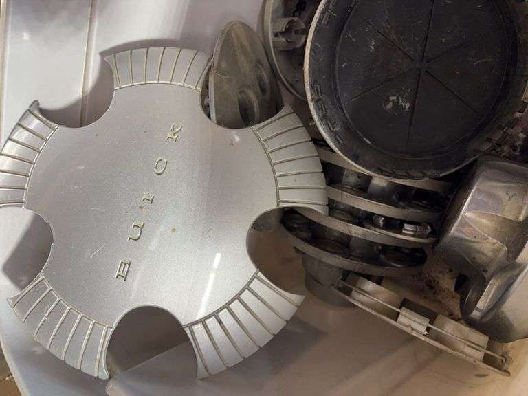 Tote of hub caps and parts -Chevy, Buick, and more