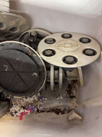 Tote of hub caps and parts -Chevy, Buick, and more