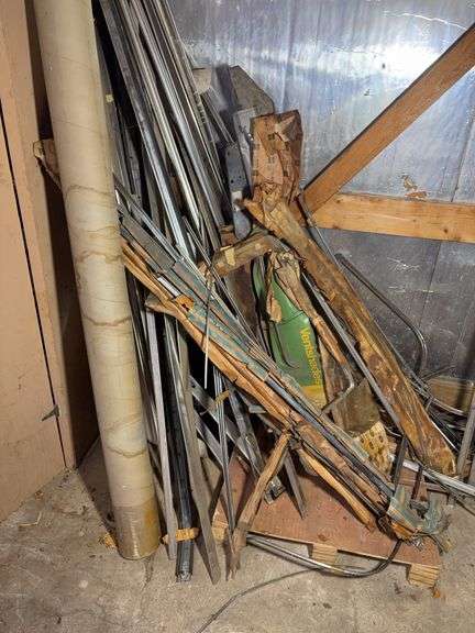 Corner of car parts and scrap metal pieces - as is