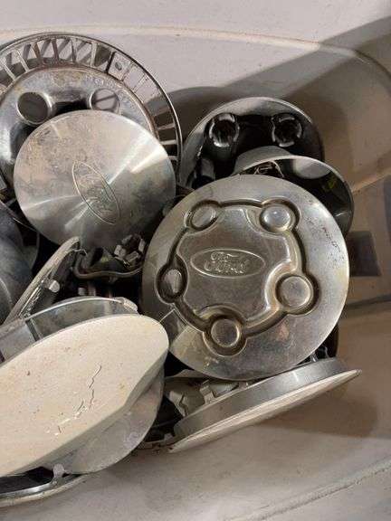 Tote of miscellaneous hub caps and parts -Ford, Toyota and more