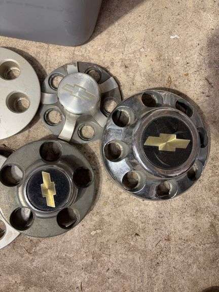 Tote of Chevy hub caps and parts
