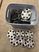 Tote of Chevy hub caps and parts