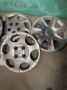 Large tote of hub caps and parts -Hyundai, Eagle and more