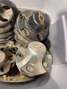 Tote of Chevy hub caps and parts