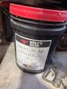 Bucket of hydraulic oil, extension cord, gas nozzles, and more