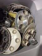 Tote of Chevy hub caps and parts