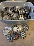 Large tote of Chevy hub caps and parts