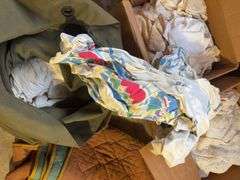 Boxes of rags, military bag, and blankets