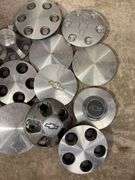 Tote of Chevy hub caps and parts