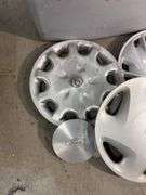 Tote of miscellaneous hub caps and parts -Ford, Toyota and more