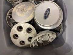 Tote of Ford hub caps and parts