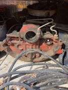 Bucket of hydraulic oil, extension cord, gas nozzles, and more