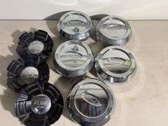 Box of Ford and Ruff racing hub caps