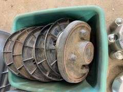 Tote of Ford hub caps and parts and small tote of Wheel cover locks