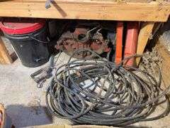 Bucket of hydraulic oil, extension cord, gas nozzles, and more