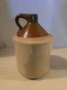 BROWN TOP 1 GALLON CROCK JUG HAS HAIRLINE ON BOTTOM