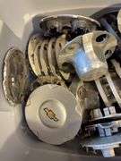 Large tote of Chevy hub caps and parts