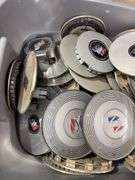 Tote of Buick hub caps and parts