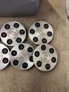 Tote of Chevy hub caps and parts