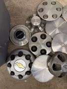 Tote of Chevy hub caps and parts