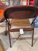 (2) cushioned folding chairs and shop towels