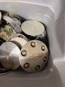 Tote of Chevy hub caps and parts