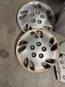 Tote of hub caps and parts -Nissan, Chevy, Ford and more