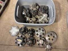 Tote of Chevy hub caps and parts