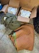 Boxes of rags, military bag, and blankets