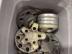 Tote of Chevy hub caps and parts