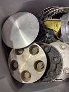 Tote of Chevy hub caps and parts