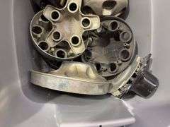 Tote of Chevy hub caps and parts