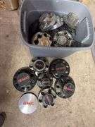 Tote of GMC hub caps and parts