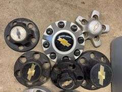 Tote of Chevy hub caps and parts