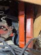 Bucket of hydraulic oil, extension cord, gas nozzles, and more