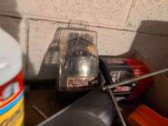 Shelf of drill bits, wire grinder, toy Tonka truck, and more