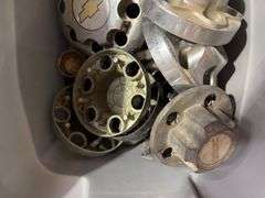 Tote of GMC hub caps and parts